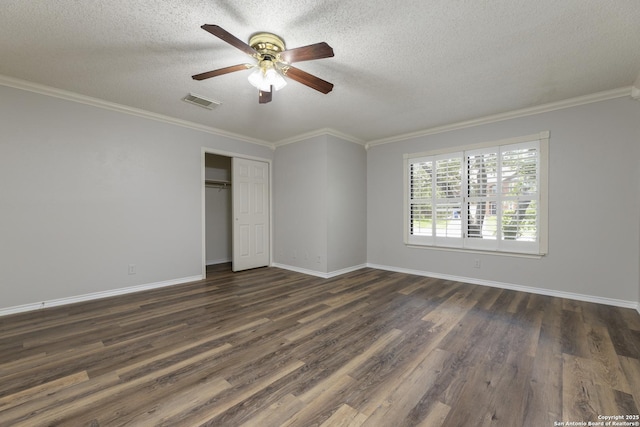 18510 Paloma Wood, San Antonio, TX 78259 - unfurnished bedroom featuring dark wood-style flooring, a textured ceiling, a closet, ornamental molding, and a ceiling fan