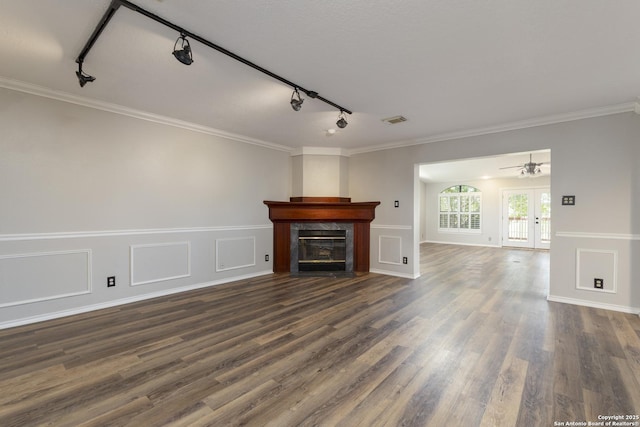 18510 Paloma Wood, San Antonio, TX 78259 - unfurnished living room with rail lighting, dark wood-type flooring, a high end fireplace, ornamental molding, and french doors