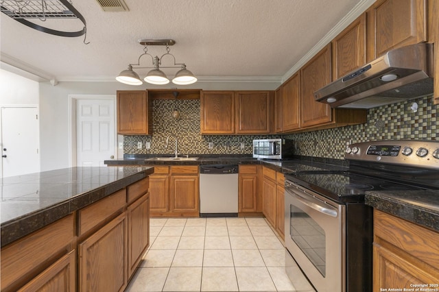18510 Paloma Wood, San Antonio, TX 78259 - kitchen with appliances with stainless steel finishes, under cabinet range hood, crown molding, decorative backsplash, and brown cabinets