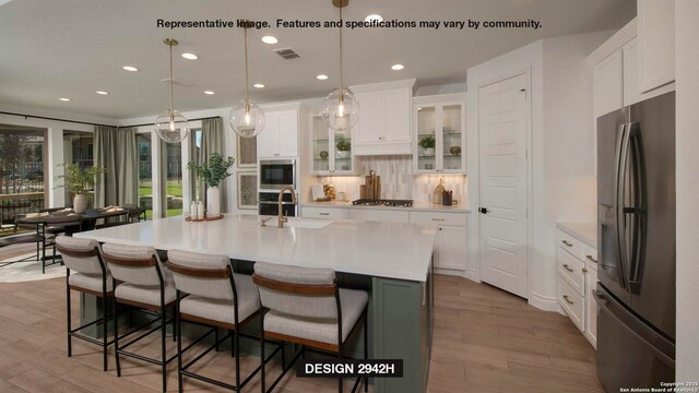 9742 Slick Frk, San Antonio, TX 78254 - kitchen featuring appliances with stainless steel finishes, wood finished floors, light countertops, recessed lighting, and white cabinets