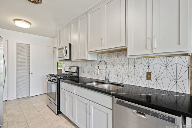 250 Maplewood, San Antonio, TX 78216 - kitchen with appliances with stainless steel finishes, backsplash, white cabinetry, and light tile patterned floors