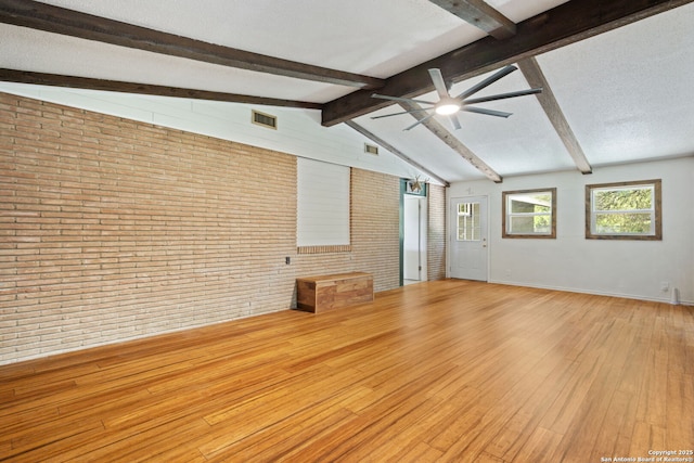 250 Maplewood, San Antonio, TX 78216 - unfurnished living room featuring brick wall, wood-type flooring, and ceiling fan