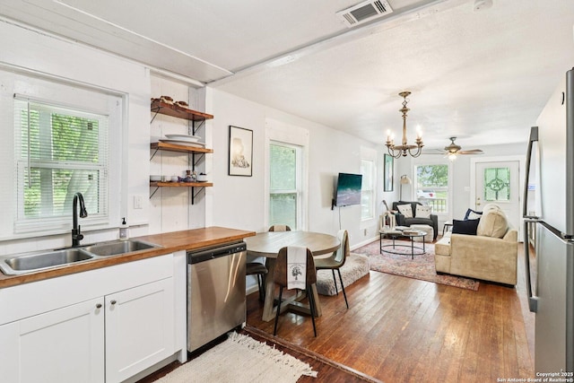 107 W Gilbert, Falls City, TX 78113 - kitchen featuring appliances with stainless steel finishes, light wood finished floors, plenty of natural light, and a chandelier