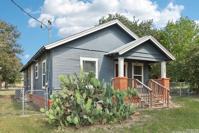 107 W Gilbert, Falls City, TX 78113 - shotgun-style home featuring covered porch and a gate