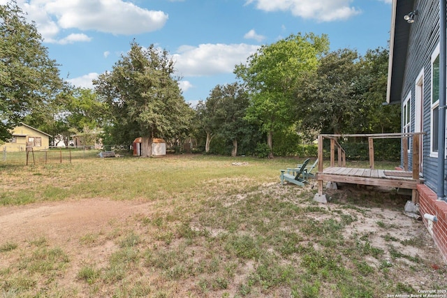 107 W Gilbert, Falls City, TX 78113 - view of yard featuring a shed, a deck, and view of wooded area