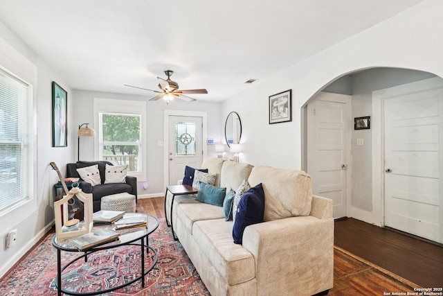 107 W Gilbert, Falls City, TX 78113 - living area with arched walkways, dark wood finished floors, and ceiling fan