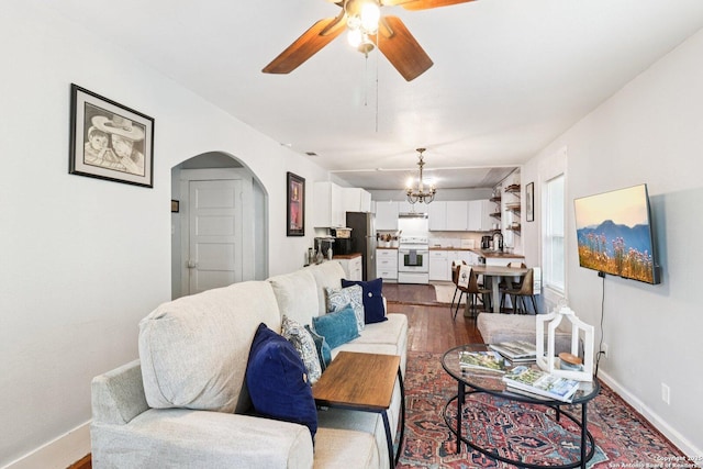 107 W Gilbert, Falls City, TX 78113 - living room with ceiling fan, arched walkways, dark wood finished floors, and a chandelier