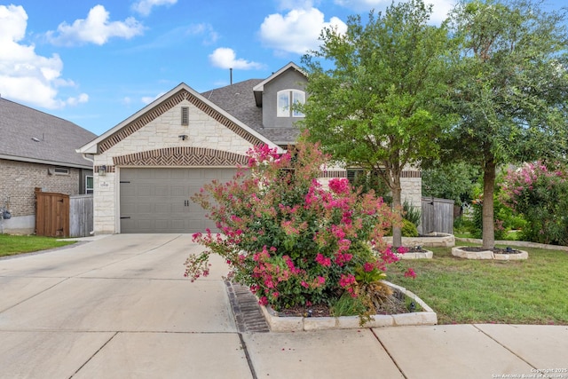 11910 Wilby, San Antonio, TX 78253 - view of front of home with stone siding, an attached garage, driveway, and a shingled roof
