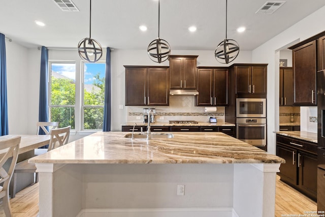 11910 Wilby, San Antonio, TX 78253 - kitchen with appliances with stainless steel finishes, light stone counters, light wood-style floors, tasteful backsplash, and recessed lighting