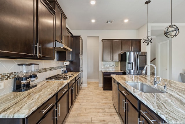 11910 Wilby, San Antonio, TX 78253 - kitchen featuring stainless steel appliances, dark brown cabinetry, light stone counters, backsplash, and recessed lighting