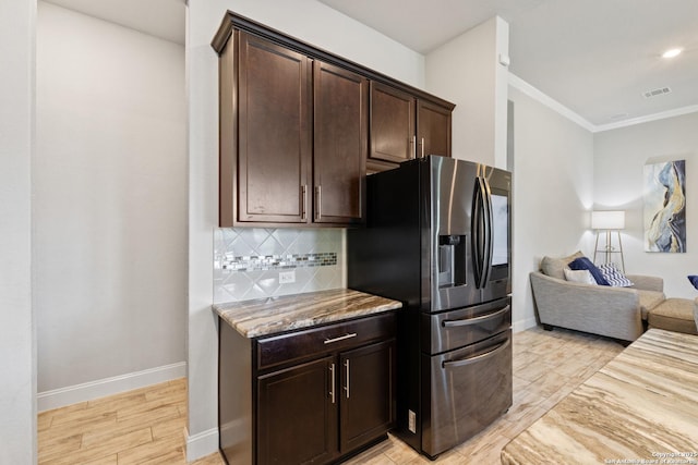 11910 Wilby, San Antonio, TX 78253 - kitchen with refrigerator with ice dispenser, open floor plan, light stone countertops, dark brown cabinets, and tasteful backsplash