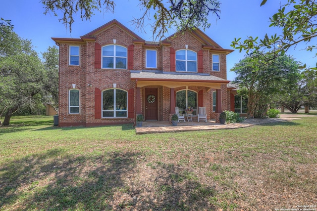 577 River Chase, New Braunfels, TX 78132 - traditional-style home with a front yard, brick siding, and covered porch