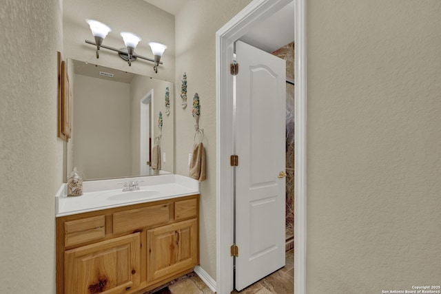 577 River Chase, New Braunfels, TX 78132 - bathroom featuring vanity, a textured wall, and a shower
