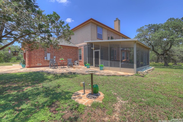 577 River Chase, New Braunfels, TX 78132 - rear view of property featuring a sunroom, a chimney, a patio, and a lawn
