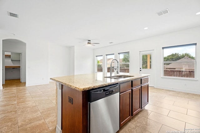 105 Highland Pl, Cibolo, TX 78108 - kitchen featuring dishwasher, arched walkways, ceiling fan, light stone counters, and a center island with sink