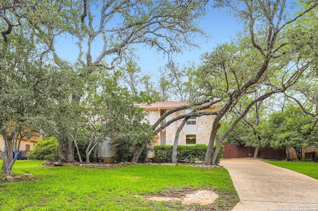14339 Hill Prince, San Antonio, TX 78248 - view of front facade featuring stone siding, driveway, and a front lawn