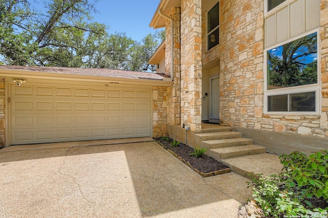 14339 Hill Prince, San Antonio, TX 78248 - property entrance with stone siding, an attached garage, driveway, and a shingled roof