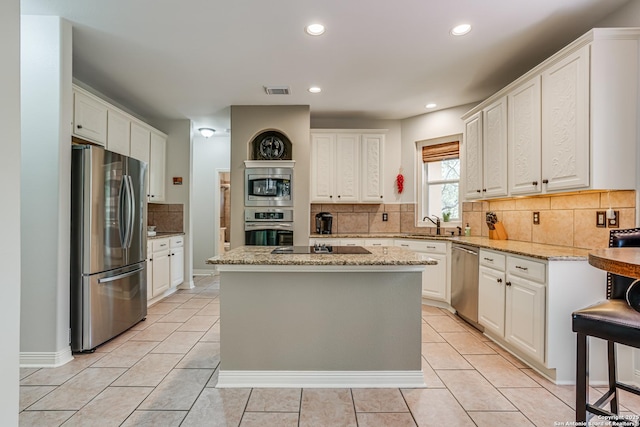 13610 Pearlstone, San Antonio, TX 78232 - kitchen with stainless steel appliances, recessed lighting, backsplash, a kitchen island, and light tile patterned floors