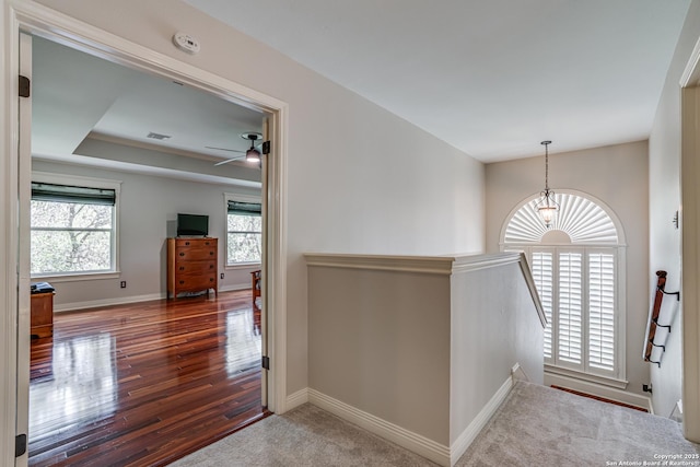 13610 Pearlstone, San Antonio, TX 78232 - hallway featuring an upstairs landing, wood finished floors, and a tray ceiling