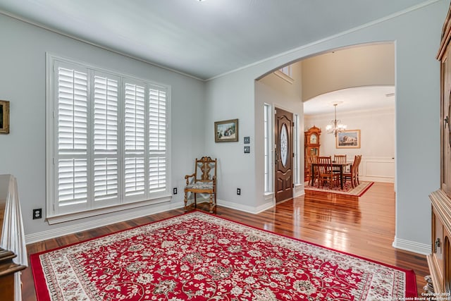 13610 Pearlstone, San Antonio, TX 78232 - living area with arched walkways, wood finished floors, a chandelier, and ornamental molding