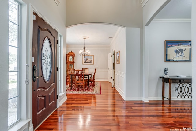13610 Pearlstone, San Antonio, TX 78232 - entryway with arched walkways, wood finished floors, ornamental molding, and a chandelier