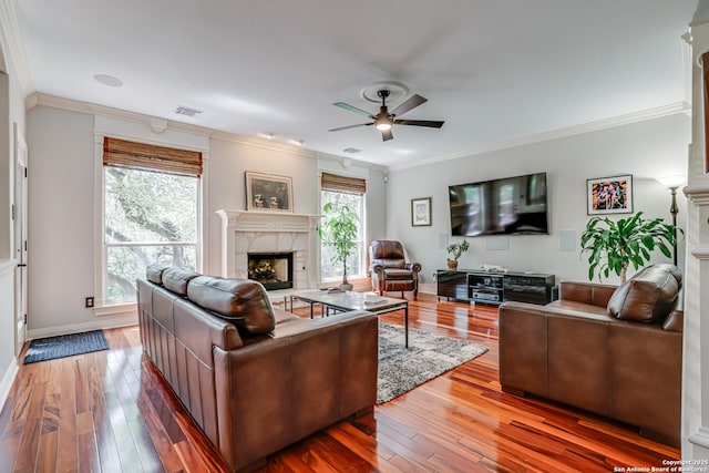 13610 Pearlstone, San Antonio, TX 78232 - living room with a fireplace, a ceiling fan, wood-type flooring, and crown molding