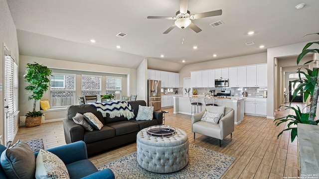 5322 Silent Dusk, Bulverde, TX 78163 - living room featuring light wood-style floors, vaulted ceiling, a ceiling fan, and recessed lighting