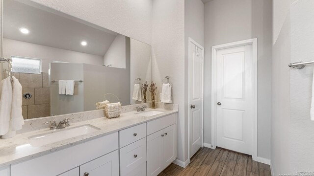 5322 Silent Dusk, Bulverde, TX 78163 - full bathroom featuring double vanity, wood finished floors, and tiled shower