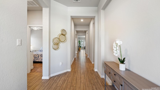 5322 Silent Dusk, Bulverde, TX 78163 - corridor featuring light wood-style flooring and baseboards