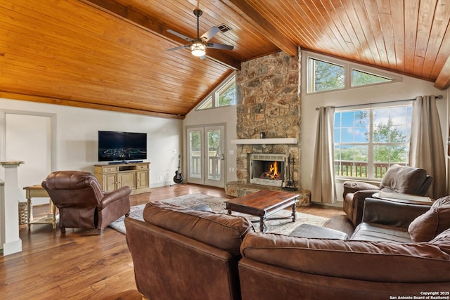 611 Wild Turkey, New Braunfels, TX 78132 - living room with a stone fireplace, a wooden ceiling with exposed beams, a ceiling fan, light wood-style flooring, and high vaulted ceiling