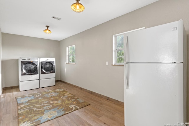 611 Wild Turkey, New Braunfels, TX 78132 - laundry room featuring separate washer and dryer and wood finished floors