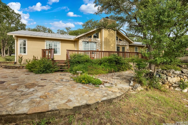 611 Wild Turkey, New Braunfels, TX 78132 - back of property featuring a deck, a patio, a standing seam roof, and a metal roof