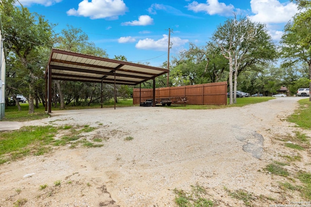 611 Wild Turkey, New Braunfels, TX 78132 - view of parking / parking lot featuring dirt driveway and a detached carport