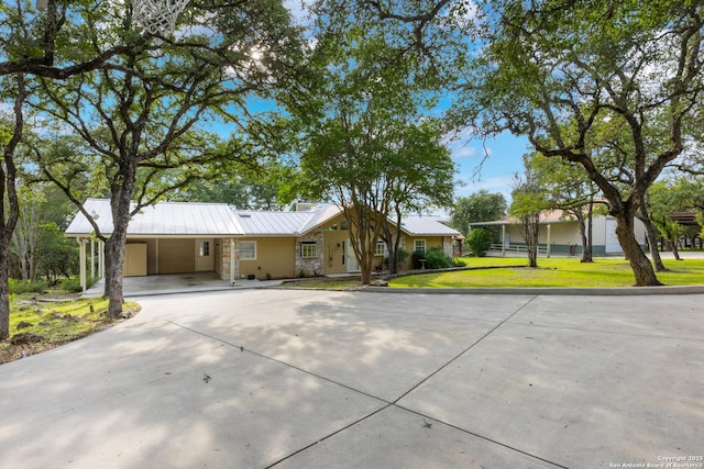 611 Wild Turkey, New Braunfels, TX 78132 - ranch-style house with concrete driveway, a front yard, a carport, and a metal roof