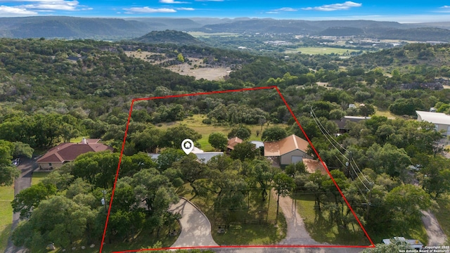 611 Wild Turkey, New Braunfels, TX 78132 - aerial view of property and surrounding area featuring property parcel outlined and a mountain backdrop