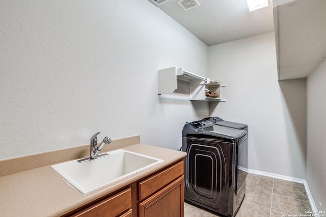 25547 Veining, San Antonio, TX 78261 - laundry area with washer / clothes dryer, cabinet space, and light tile patterned floors