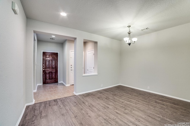 25547 Veining, San Antonio, TX 78261 - spare room with wood finished floors, a chandelier, and recessed lighting