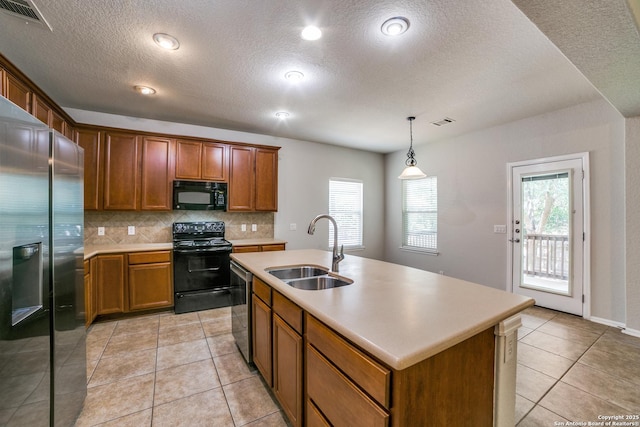 25547 Veining, San Antonio, TX 78261 - kitchen with black appliances, tasteful backsplash, a textured ceiling, light countertops, and brown cabinetry