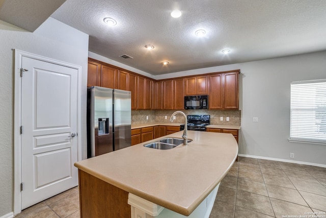 25547 Veining, San Antonio, TX 78261 - kitchen with black appliances, backsplash, light tile patterned floors, light countertops, and a textured ceiling