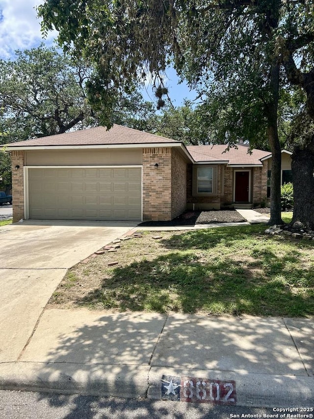 8602 Wood Peak, San Antonio, TX 78251 - ranch-style home featuring brick siding, a garage, driveway, and a front lawn