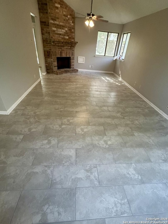 8602 Wood Peak, San Antonio, TX 78251 - unfurnished living room with ceiling fan, vaulted ceiling, and a brick fireplace