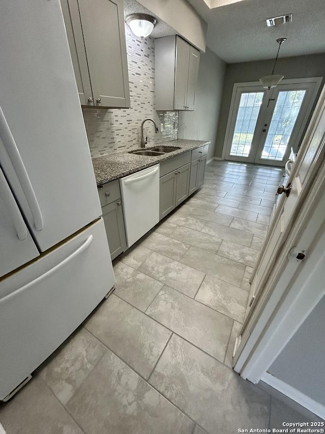 8602 Wood Peak, San Antonio, TX 78251 - kitchen featuring white appliances, gray cabinets, backsplash, stone countertops, and french doors