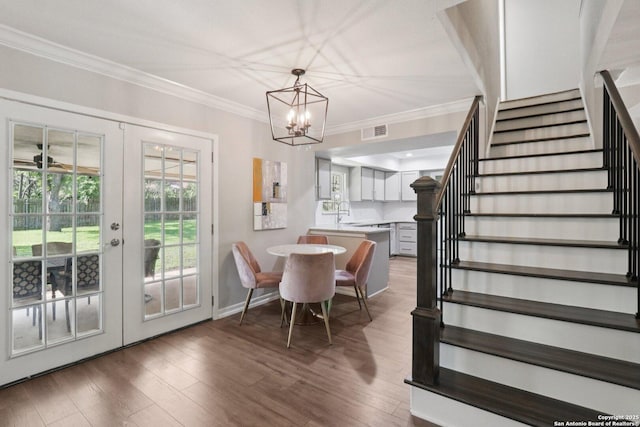 1710 Searcy, San Antonio, TX 78232 - dining space featuring french doors, stairs, ornamental molding, wood finished floors, and a chandelier