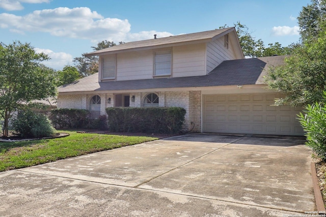 1710 Searcy, San Antonio, TX 78232 - view of front of home featuring concrete driveway, a garage, a front lawn, and brick siding