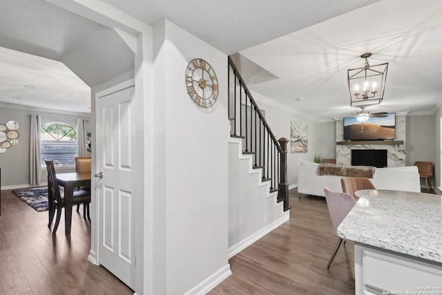 1710 Searcy, San Antonio, TX 78232 - stairs with ornamental molding, wood finished floors, a chandelier, and a premium fireplace