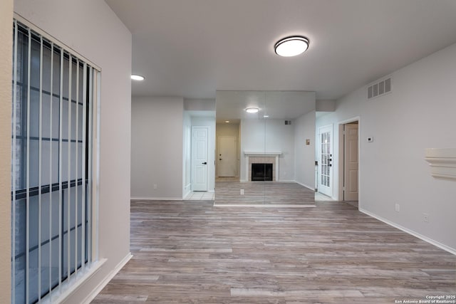 11839 Parliament Unit 511, San Antonio, TX 78216 - unfurnished living room with wood finished floors, a tile fireplace, and recessed lighting