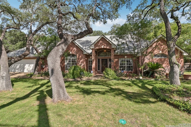 127 Sunflower Ln, San Antonio, TX 78213 - view of front facade featuring brick siding, a front yard, and an attached garage