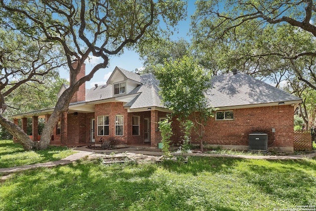 127 Sunflower Ln, San Antonio, TX 78213 - back of property with a chimney, brick siding, a yard, and roof with shingles