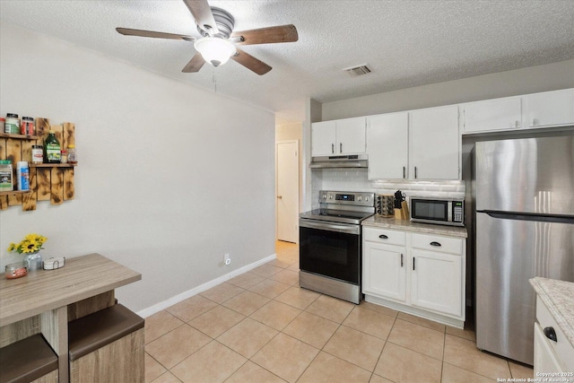 5311 Light House, San Antonio, TX 78242 - kitchen with stainless steel appliances, under cabinet range hood, a ceiling fan, backsplash, and a textured ceiling