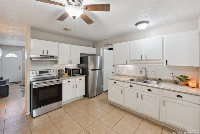 5311 Light House, San Antonio, TX 78242 - kitchen with appliances with stainless steel finishes, under cabinet range hood, decorative backsplash, a textured ceiling, and ceiling fan